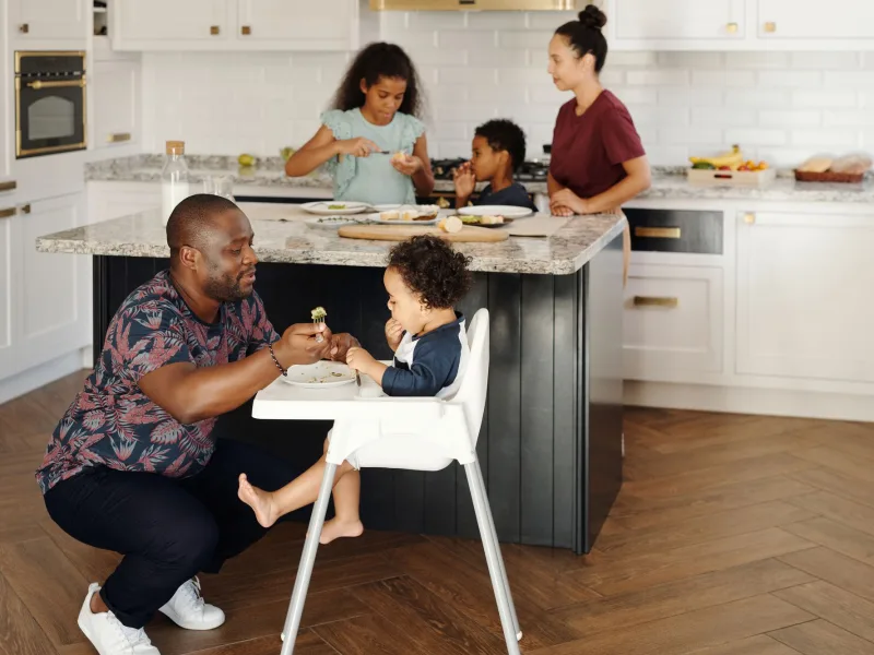 A family together in the kitchen of a home on the Jupiter coast