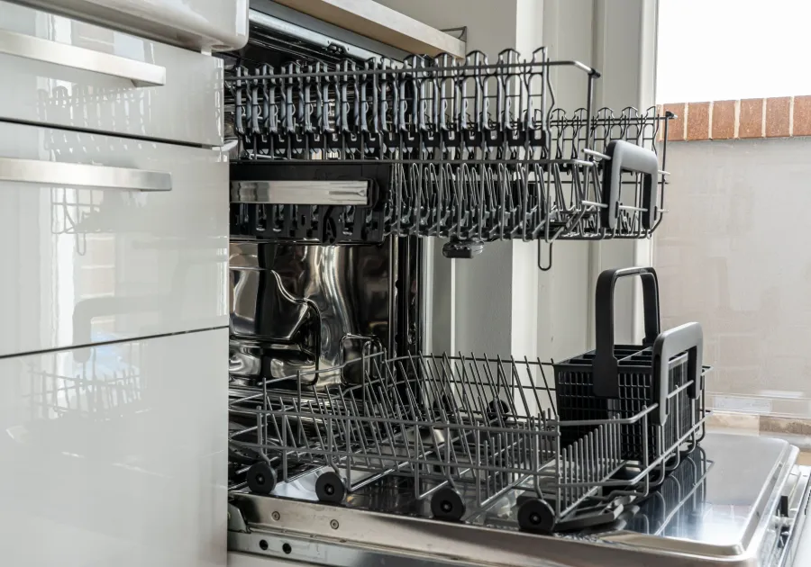 Open dishwasher loaded with clean glassware