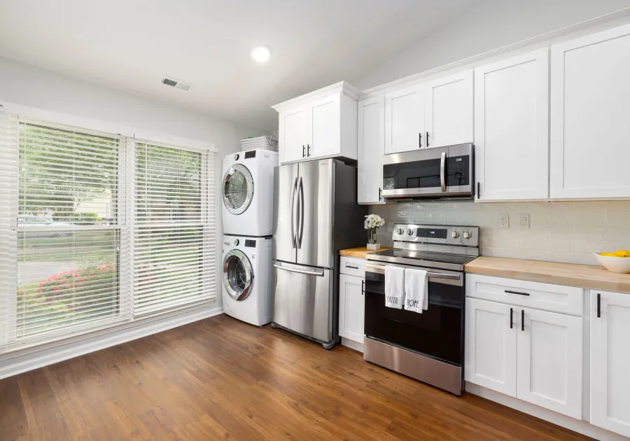 Bright laundry room with a washer and dryer beside a window