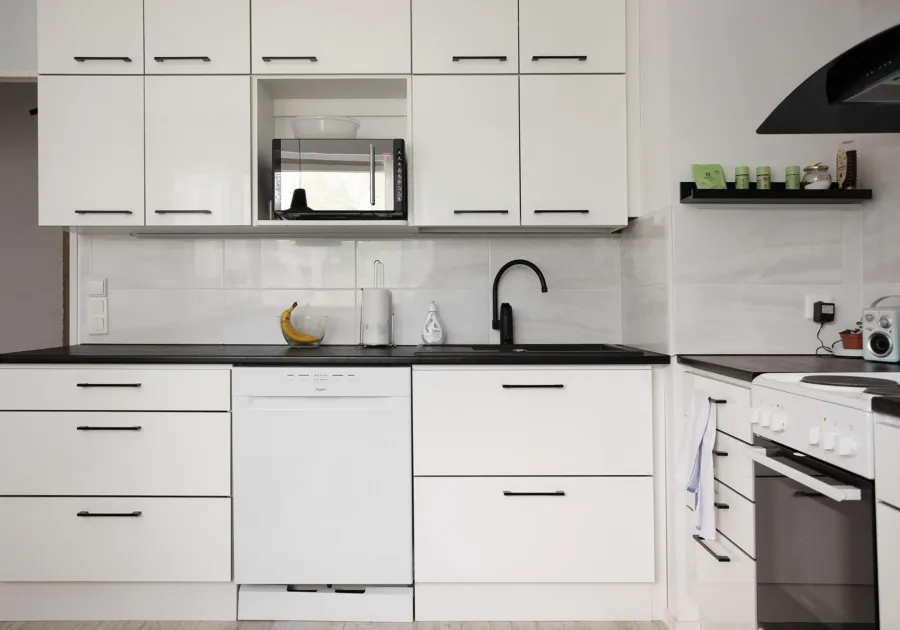 Run of built-in kitchen cabinetry with an integrated drawer front
